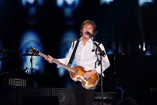 Paul McCartney on stage with his classic bass guitar