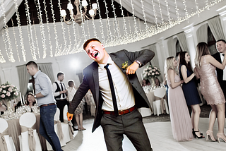 A wedding guest dancing.