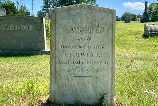 A grave marker reads “Luther D Crowell, son of Daniel & Caroline, died July 11, 1864. Aged 16 years.”