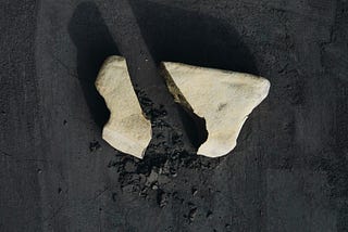 grey-rock-split-in-half-on-black-background