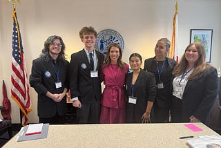 SGA members smiling with a legislator.