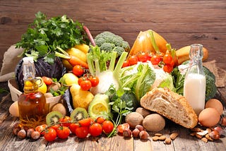 Image of variety of groceries against a wood background