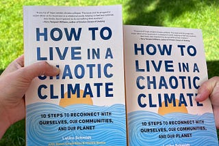 Two hands holding up two “How to Live in a Chaotic Climate” books