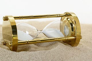 A photo of an hourglass on its side, signifying the disruption of time passing.