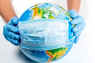 Hands with surgical gloves on holding a medical mask over North America, symbolizing the fight against COVID-19.