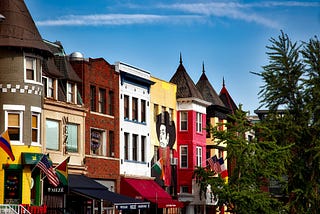 Colorful rowhouses in Washington DC below blue sky
