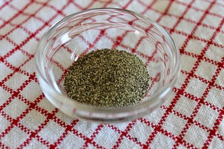 Small glass bowl of cracked black pepper