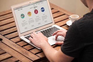 An HD image of a guy working on a laptop. This image is for the blog The Benefits of Implementing a B2B SaaS Solution in Your Business