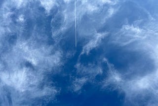 Swirling clouds in the sky with a plane flying through the centre
