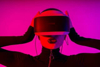 pink tone contrast photo of woman wearing futuristic headset around eyes