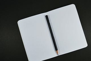 image of a open empty notebook with a pencil in the middle