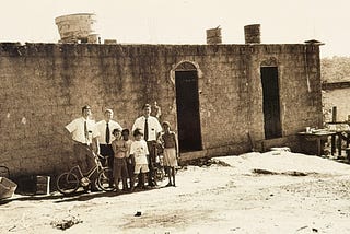 A picture from my church mission; standing in front of a home where we taught a family