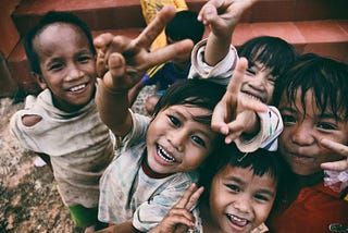 A group of young children smiling for the camera