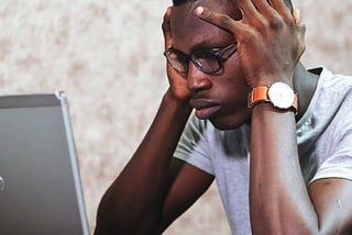 Man looking at computer frustrated or confused