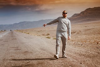 Man abandoned by the side of a road in the desert