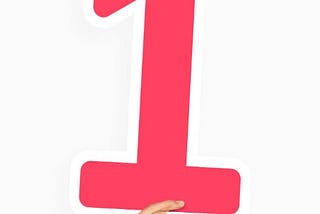 Hand holding a red number 1