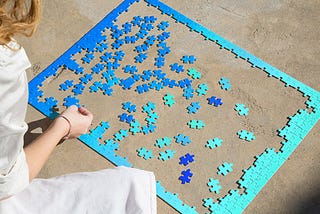 A woman putting a puzzle together