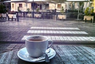 Morning coffee by an empty square. Main image to the personal essay ‘Life Without a Map’ by MARTIN WÆRN and the Shearwater Chronicles.