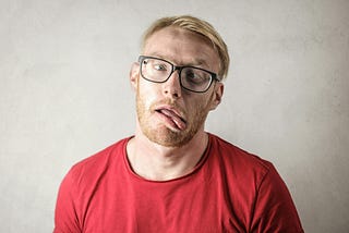 Blond man sticking out tongue