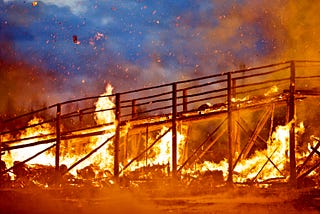 A literal burning bridge representing the metaphorical idea.