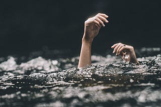 Hands above water while drowning