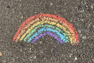 A chalk rainbow drawn on a pavement