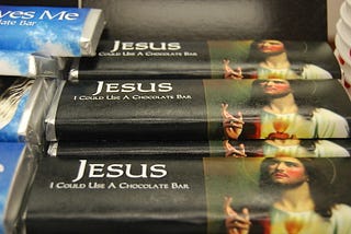 A stack of chocolate bars called “Jesus I Could Use A Chocolate Bar” with an image of Jesus.