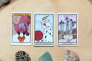 tarot cards with quartz stone on wood