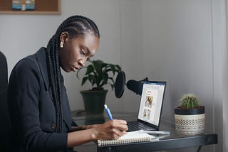 A woman in a black shirt working on a computer