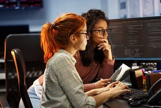 Two women conducting a pair programming / code review session