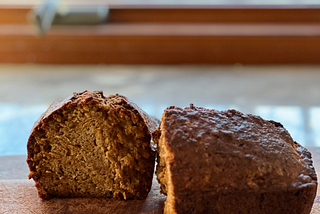 Apple carrot bread on a wooden board in front of a window