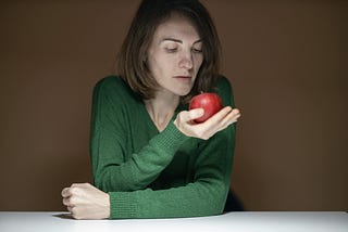 Woman staring at an apple
