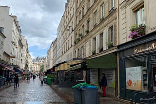 A rainy day on the cobblestone streets of rue Cler in Paris, France