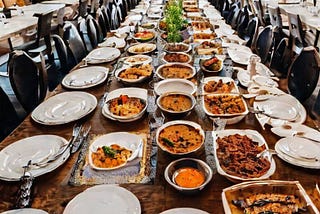 The long dining table was filled with a variety of sumptuous dishes.
