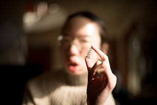 A spring about 5 cm long, with about 5 revolutions. Aubrie holds it up in front of her face.