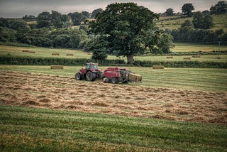 Tractor baling hay in a field