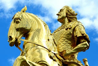 A Fisher King riding on a horse gold statue
