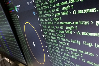 Computer screens with cyber security programs running in background