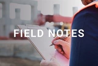 The title “Field Notes” is in the foreground while an image of a construction worker holding a note pad is in the background.