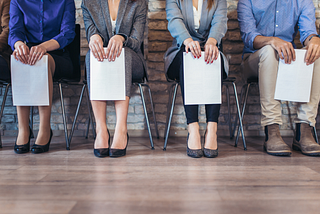 Photo of candidates waiting for a job interview, legs