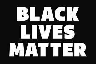“Black lives matter” written on a black background.