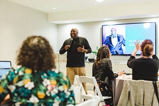 Man speaking at a conference.