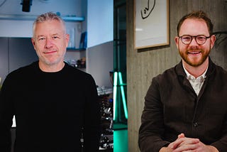 Staffan on the left wearing a black jumper looking into the camera and Joe on the right wearing glasses and a brown jacket smiling into the camera