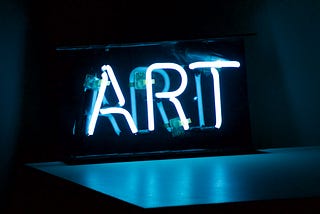 Neon sign that reads “ART”.