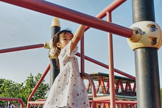 Child climbing on a jungle gym