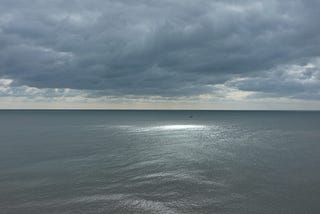 A moody sea and sky, with sun breaking through the clouds. taken on the south coast of the UK.