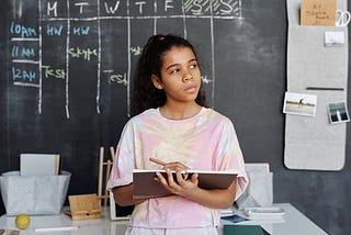 Young lady thinking about how to start writing to participate in the writing contest