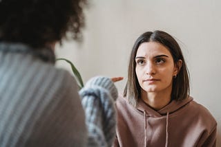 a woman pointing the finger at another woman