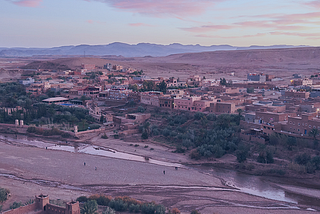 Image shows a picture of Marrakesh in Morocco with a river with very low flow