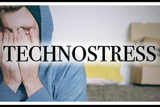 A banner image with the word “TECHNOSTRESS” in bold, black letters across the center. In the background, a person wearing a blue hoodie is sitting with their hands covering their face, appearing stressed. The background also includes some blurred out objects, such as a couch and cardboard boxes, emphasizing a feeling of clutter and stress.